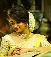 What A Beautiful Large Low Bun With Real Flower Gajra Care However Should Be Taken Before South Indian Bride Hairstyle Indian Bride Hairstyle Saree Hairstyles