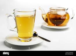 Glass Of Tea And Teapot The Tea Bag Can Be Seen In The Pot Stock Photo Alamy