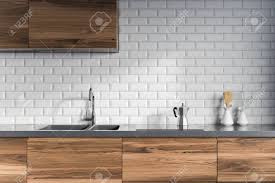 In over 10 years, we have designed numerous projects for clients and repeat clients as once someone works with us, they seem to want to do it again. Modern Kitchen Interior With White Brick Walls Dark Wooden Countertops Stock Photo Picture And Royalty Free Image Image 98027099