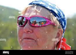 Wanda Robbins, Camp Hill, Pa., listens as Pastor Robert Straub, Calvary  Independent Church, (reflected in sunglasses) blesses her and her husband  Woody and their Victory motorcycle in the parking lot of the