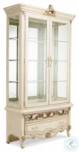 This china cabinet features a cottage white finish with dark brown top and open shelf. Platine De Royale Champagne Curio Cabinet From Aico Coleman Furniture