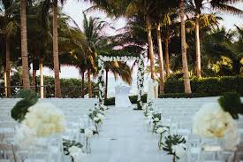 They stand outside the church, greeting and directing the early guests to the appropriate seating arrangements and handing out programs or service notes and boutonnières for guests. T Ceremony Aisle Decor Orchids By Lupe