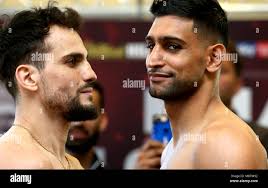 Amir Khan (right) and Phil Lo Greco (left) during the weigh-in at Liverpool  Hilton Hotel Stock Photo