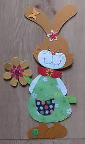 Einen luftballon, kleister, zeitungspapier, backpapier oder braunes transparentpapier, tonpapier in. Fensterbild Tonkarton Fruhling Ostern Ein Osterhasen Madchen Mit Blume Ostern Basteln Holz Basteln Fruhling Ostern Blumen Basteln