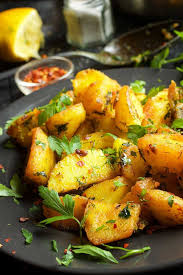 Batata Harra Spicy Roasted Potatoes Gourmandelle Recipe Egyptian Potato Recipe Turmeric Recipes Spicy Roasted