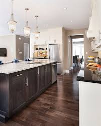 A varied tile backsplash and white cabinets were chosen to pair with the flooring, and overhead exposed beams featuring dark wood mirror what's below. Can I Have Light Kitchen Cabinets With Dark Floors