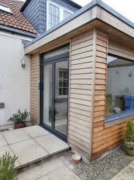 A Solarlux Sl60e Bi Fold Door Installation Installed Within A Larch Clad Contemporary Extension Design Wood Cladding Exterior House Exterior House Extensions