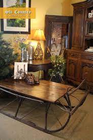 Antique sleigh runners and reclaimed barn wood were used to create this lovely sleigh coffee table. Sleigh Coffee Table Coffee Table Antique Coffee Tables Decorating Coffee Tables