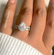 Beautifully Feminine This Enchanting Teardrop Shape Simulated Diamond Cz Is Surrounded By A Wedding Rings Teardrop Wedding Rings Unique Elegant Wedding Rings