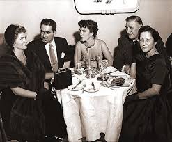 Beautiful flowers make the most appropriate decorations on the groundwork of immaculate linen and under the soft rays of the candelabra or banquet lamps. Margaret Lockwood And Guests At A Formal Dinner Party