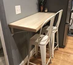 The efficient, versatile table mounts to the wall, and is a true jack of all trades: Folding Dining Table Breakfast Bar Hometalk