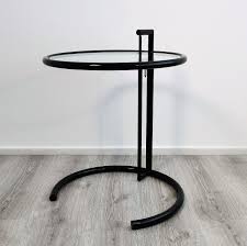 This high quality reproduction side table is manufactured in tubular stainless steel with a tempered glass top and is height adjustable. Adjustable E 1027 Side Table By Eileen Gray 129035