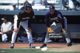 Mark Grace of the Arizona Diamondbacks covers Larry Walker of the... News  Photo