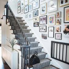 Ledges jutting outward from a wall expand display space in a gallerylike stairwell. Art Along Staircase Design Ideas