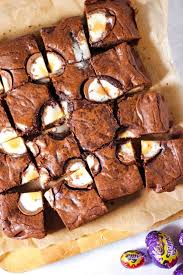 Creme Egg Brownie Squares On Baking Paper On A White Background With Creme Eggs In Foil On The Side Easter Baking Treats Easter Baking Chocolate Traybake