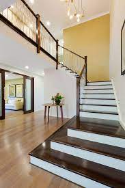 Timber Treads With Painted Risers And Stainless Steel Balustrades Give A Luxury Look To This Grand Staircase Home Builders New Home Builders Timber Staircase