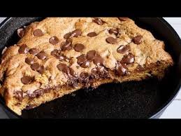 The Best Buttery And Gooey On The Inside Nutella Stuffed Deep Dish Chocolate Chip Skillet Coo Giant Cookie Recipes Skillet Chocolate Chip Cookie Cookie Recipes