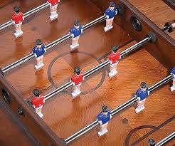 The dark walnut finish can compliment any decor. Foosball Coffee Table