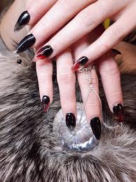 Black And Red Stiletto Nails Sculpted Smokey Black Red Stiletto Gel Nails With Piercings Chains Attached To A Ring Nail Charm Nail Charms Red Stilettos Ear Cuff