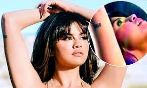 Selena gomez debuts huge upper thigh tattoo of hands praying with a rosary after her comeback performance at american music awards. Selena Gomez Shows Off Her Tattoo Commemorating 2017 Kidney Transplant In Her New Rare Video Daily Mail Online