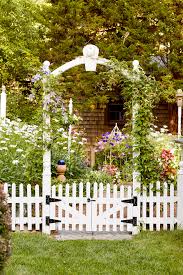 White picket fence with open gate across a country lane. Our Favorite Decorative Fence Ideas Better Homes Gardens