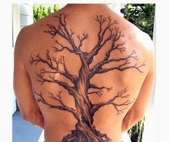So, this tattoo can be stained anywhere. Black And Brown Without Leave Tree Tattoo On Full Back