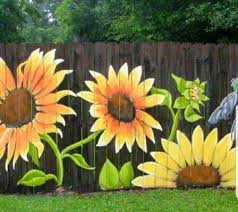 The artists used the actual fence panels , chain link, pickets and clay walls as their canvas and created backyard spaces fit for an art gallery. Sunflower Grouping 3 In First Space To See From Chair Garden Fence Art Garden Mural Fence Art
