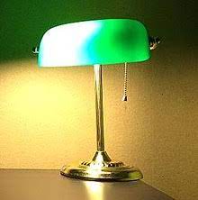 Crafted with a metal base in a sleek brass finish, this piece features a broad glass shade in a bright green hue for a splash of color. Banker S Lamp Wikipedia