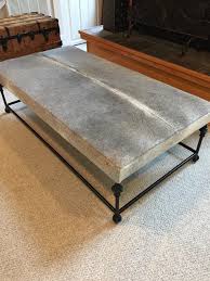 This ottoman table would work in a casual cabin or an elegant mountain mansion. Custom Cowhide Iron Base Coffee Table Ottoman Ottoman Coffee Table Coffee Table Ottoman Table