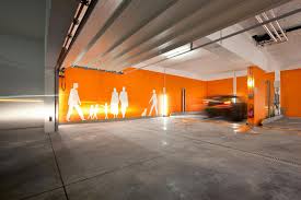 Amusing Parking Garage Designs With Orange Wall Painting And Grey Concrete Floor Garage Design Interior Parking Design Garage Interior
