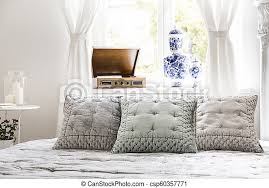 Feminine bedrooms simply cannot do without accessories. Elegant Pillows On Bed In Bright Feminine Bedroom Interior With Record Player At Window Real Photo Canstock