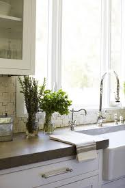 Sleek Concrete Countertops On White Shaker Kitchen Cabinetry Accented With Cream Glazed Moroccan Sty Concrete Countertops Concrete Kitchen White Shaker Kitchen
