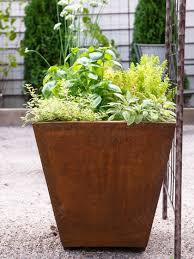 Corten steel planters corten steel planters arrive in gray steel finish and develop a rich brown rust patina over time. Corten Steel Tapered Square Planters Gardener S Supply