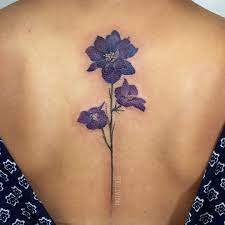 They're the birth flower of july, so keep this in mind the next time someone has a birthday!. Purple Delphinium Flower On The Spine For Paulyn Today Thank You Fintattoos Pinktattoos Purple Flower Tattoos Larkspur Flower Tattoos Flower Spine Tattoos