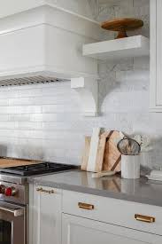 Modern thin trim, i would remove the apron, tile and then silicone it back on. White Marble Tiles With Gold Trim Design Ideas