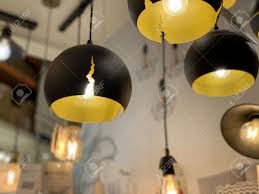 Current is supplied to the filament by terminals or wires embedded in the glass. Original Yellow Black Ceiling Lights Modern Chandeliers In The Electrical Goods Store Suspended Floor Lamps For Interior Decoration Of An Apartment Or Office Stock Photo Picture And Royalty Free Image Image 139306195