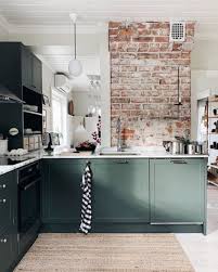 Green Cabinets And A Rough Brickwork Make This Handmade Kitchen In The Fab Finni In 2020 Dark Green Kitchen Green Kitchen Walls Brick Interior Wall