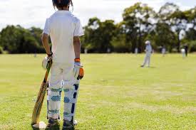 Image Of Child Wearing Pads Waiting To Bat During A Game Of Cricket Austockphoto