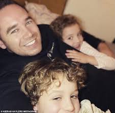 Katie Price beams as she heads out for a walk with all five children