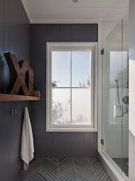 Vintage style bathroom with black white tile claw foot. Grey Bathroom Wainscoting On Walls Dark Grey Floor With White Grout Herringbone Pattern Rusty Xo L Bathroom Design Herringbone Tile Floors Bathrooms Remodel