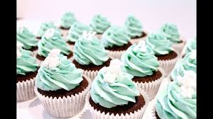 So with our darker blue with this large star tip we're going to pipe starting from the center cover a little over the cupcake and go around in a circle. How To Make Christening Baby Shower Cupcakes Youtube