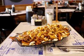 Poutine is a dish from quebec consisting of french fries and cheese curds. Playing With Your Food New Hampshire Magazine