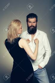 Taraji traded out her brown locks for a vibrant blonde bob at the 2016 toronto film festival premiere of hidden figures.we can always count on the golden globe winner for standout hair inspo! Young Couple Of Woman With Pretty Face And Blonde Hair In Black Vest And Handsome Bearded Man With Long Beard In White Shirt In Studio On Grey Background Stock Photo Picture And