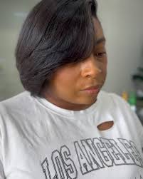 I have no idea whyyy my client was mean mugging because she loved her hair!  😂😩 This is a silk press/clipper cut bob. Last slide is of course the  before pic.