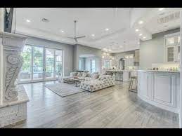 Rustic kitchen with cabinets painted in benjamin moore gettysburg grey, hardwood floors, black framed windows, and a stainless steel farmhouse sink | homebunch. Grey Wood Floors Modern Interior Design Youtube