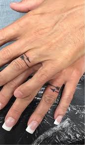 The tribal version will look better. 60 Romantic Ring Finger Tattoo Ideas Tattoo Wedding Rings Wedding Finger Tattoos Ring Tattoo Designs