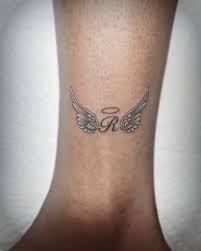 Tattoos with names | name with wings and halo lower back. Top 91 Best Angel Wings Tattoo Ideas 2020 Inspiration Guide Newsbaza