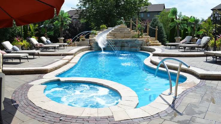 The Brilliant - freeform fiberglass swimming pool with built-in spa