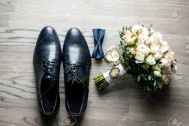 What do men have instead of bouquets wedding. On The White Floor Are Black Men S Shoes A Bouquet Of Flowers A Man S Bowtie And A Watch Close Up Photo Details Of The Wedding Stock Photo Picture And Royalty Free Image