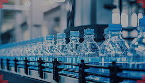 고속 컨베이어 라인 위에 설치된 캡 비전 검사기, 여러 대의 카메라와 특수 조명이 병뚜껑을 검사하는 모습